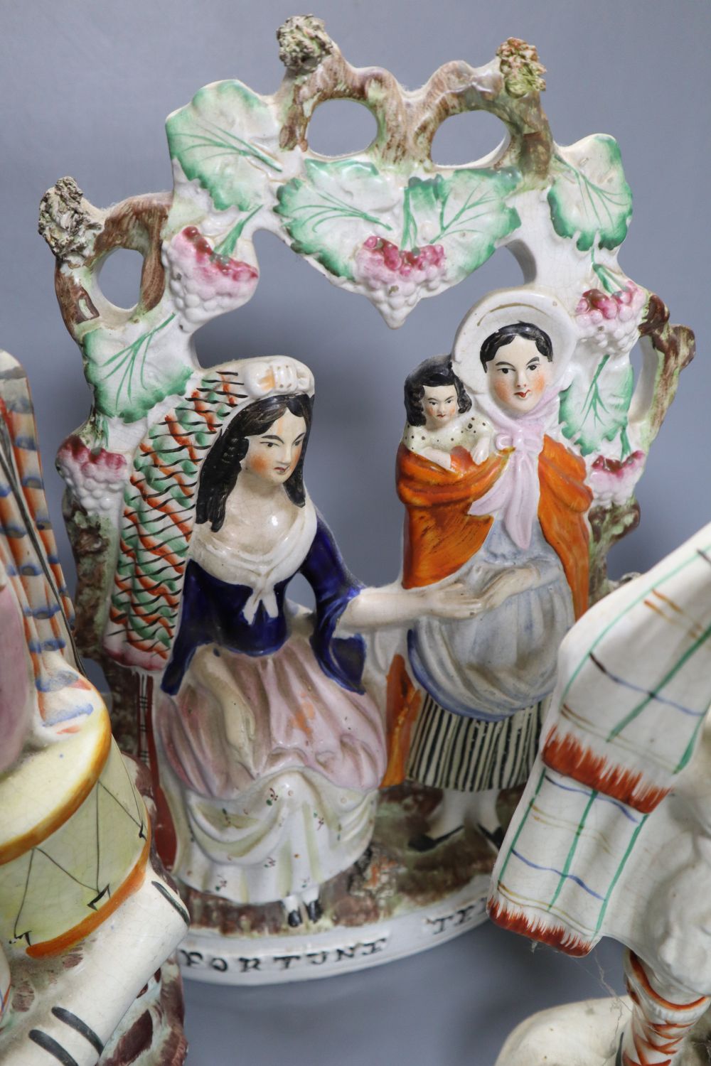 A collection of Staffordshire figures, including a flatback entitled Fortune Teller, height 32cm,